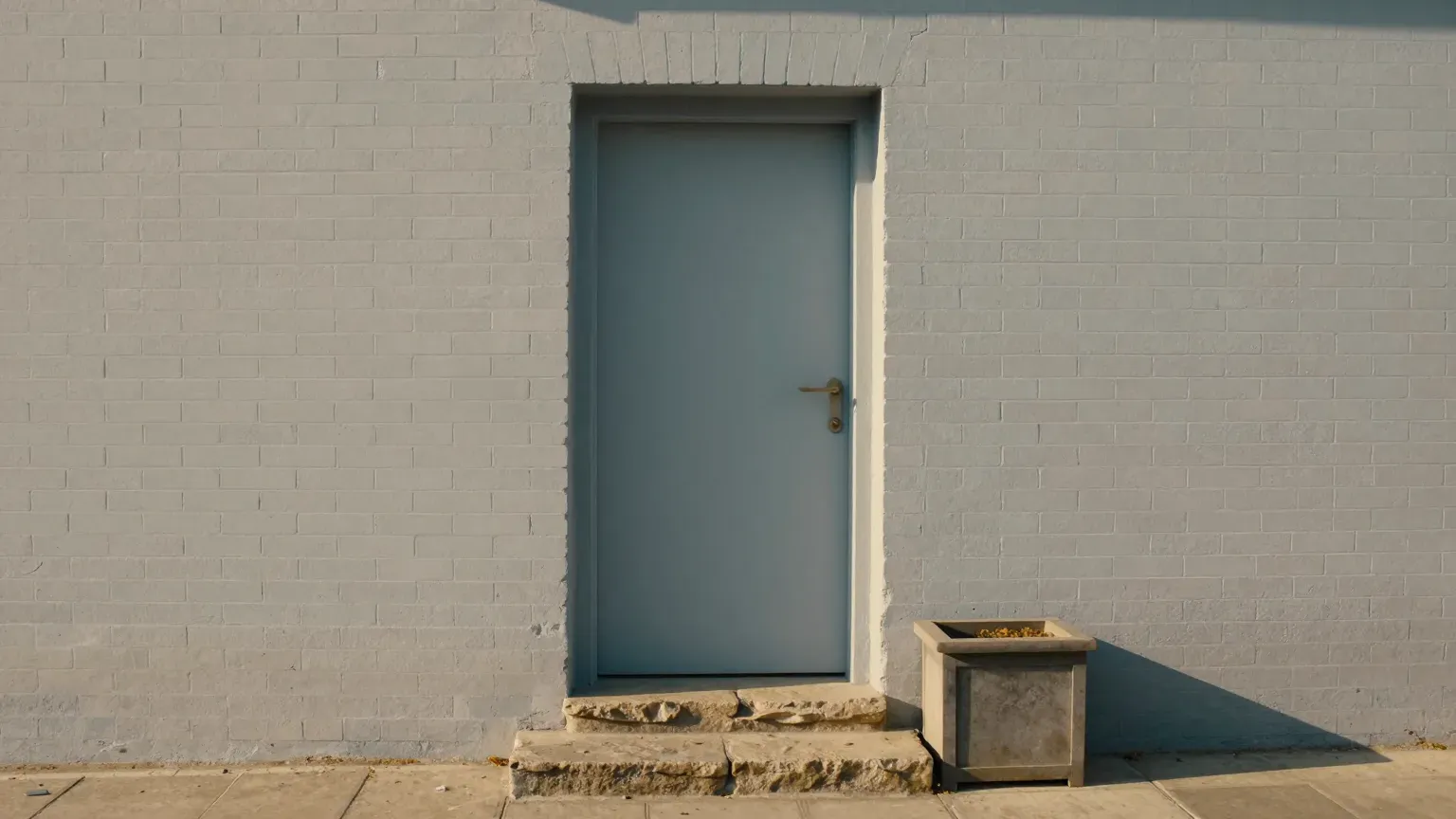 A plain doorway of a small brick building, door standing open